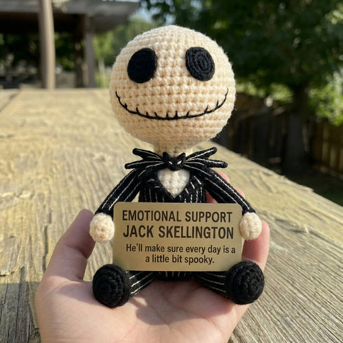 Hand holding a small crochet figure of Jack Skellington with a humorous tag.